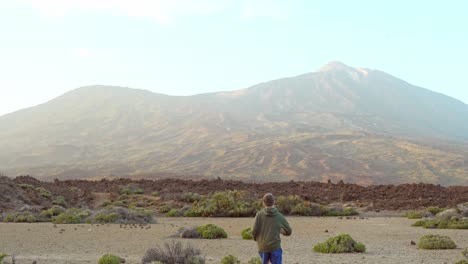 person running into desert looking like planet mars, back view