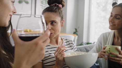 tracking video of  three friends gossiping at home