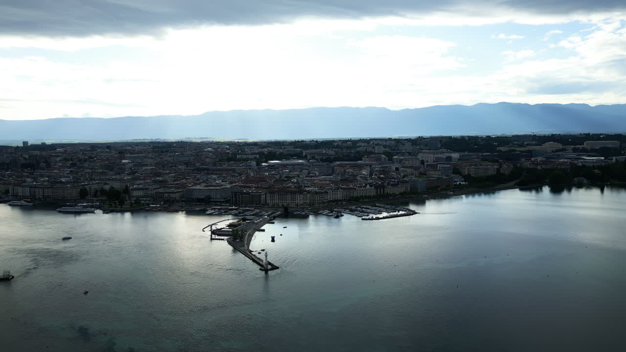Aerial: Rive Droite of Geneva during the day with Paquis Bath and Quartier des Nations during the day in canton of Geneva, Switzerland, establishing drone shot