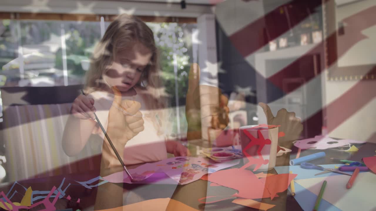 Una ragazza prende un pennello, lo intinge nella pittura e crea un lavoretto sulla carta con una sovrapposizione di bandiere per scopi educativi.