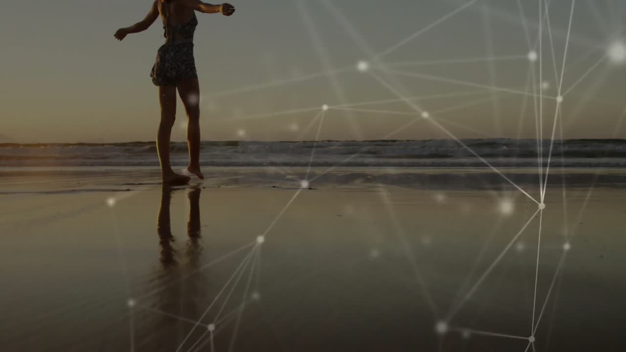 Silhouette of person walking on beach with network connections animation overlay