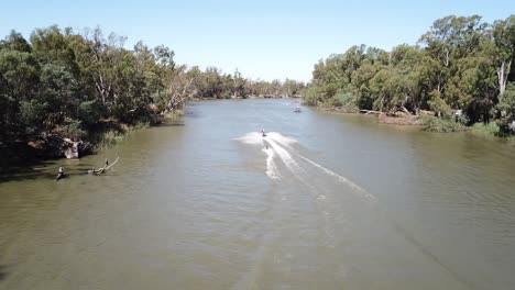 drone aerial above river with jet skis and water tubing