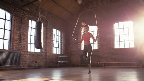 young woman skipping at the gym