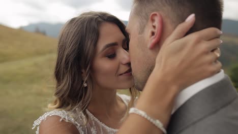 Lovely-caucasian-wedding-newlyweds-family-bride-groom-walking,-making-a-kiss-on-mountain-slope-hill