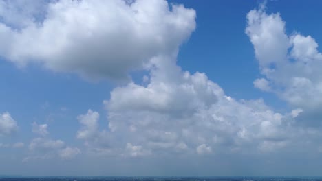 white fuffy clouds with blue sky with slow zoom in