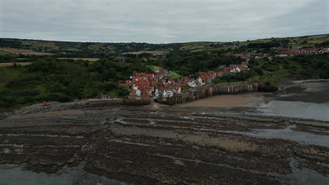 Establishing-Drone-Shot-of-Robin-Hoods-Bay-at-Low-Tide-on-Overcast-Day