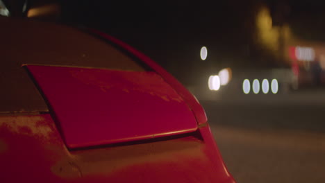 A-woman-walks-to-her-car-and-the-headlight-opens