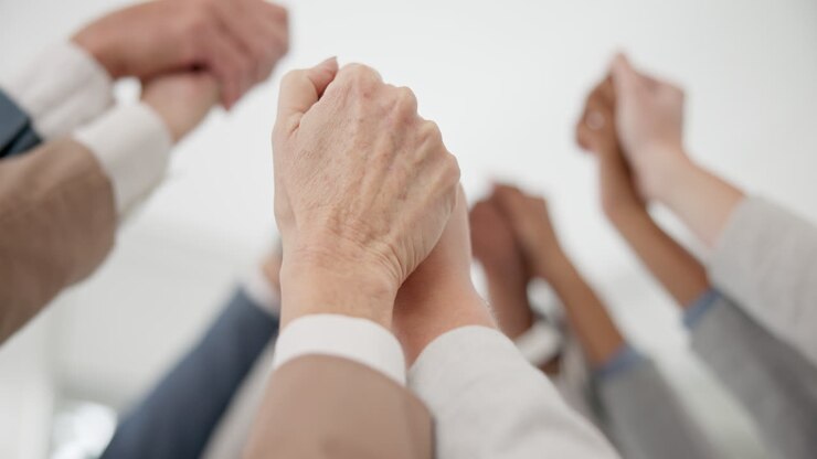Holding hands, teamwork and business people