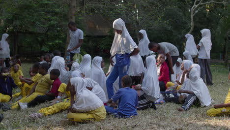 tanzanian school students gather in the forest for a break.