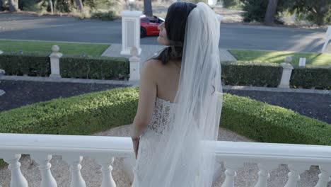 young bride looking over her shoulder as she is photographed