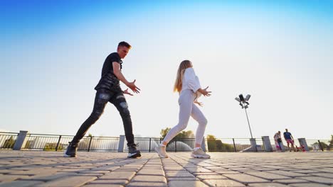 dancing couple near fountain. happy cheerful young loving couples dancing outdoors