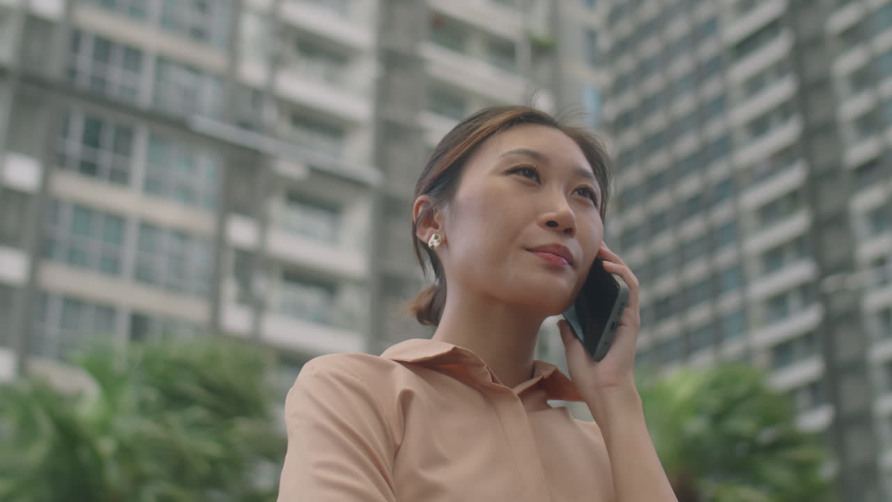 Asian Businesswoman Talking on Phone Outdoors