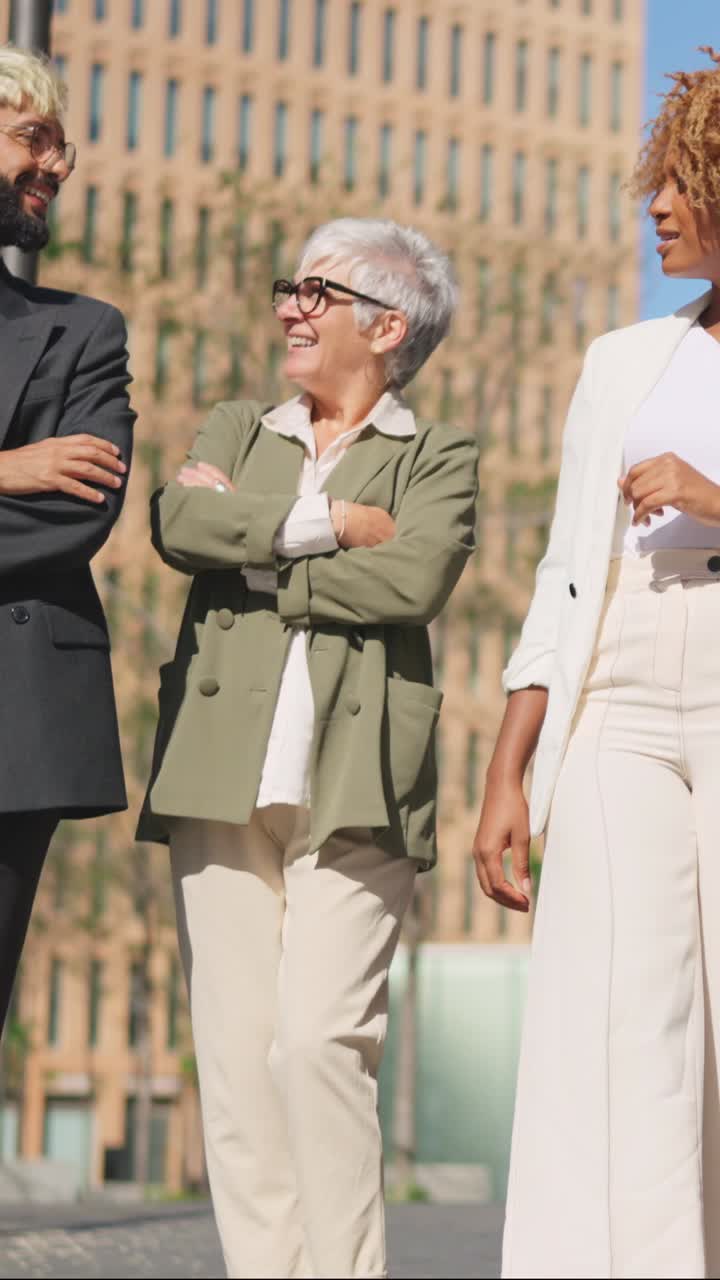 Diverse business people talking relaxed while strolling in the city