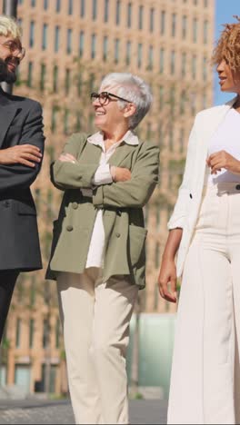 diverse business people talking relaxed while strolling in the city