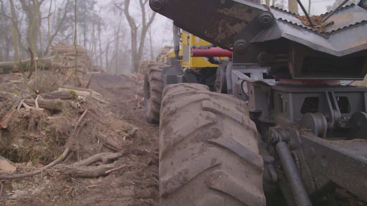 Shot of a tree excavator in the middle of a destroyed forest.