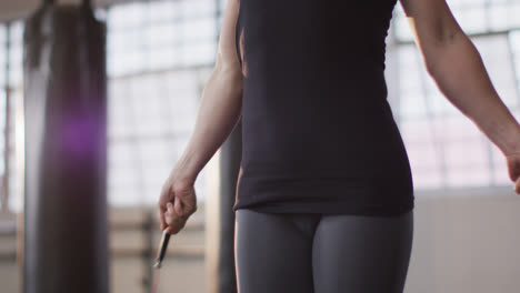 Fit-caucasian-woman-working-out-with-jump-ropes-at-the-gym