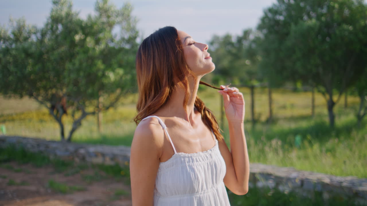 Carefree girl touching hairstyle looking camera with smile closeup. Woman posing