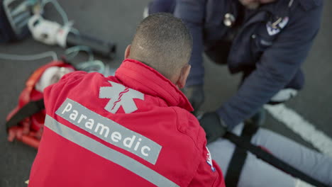 paramedic, team and man with first aid