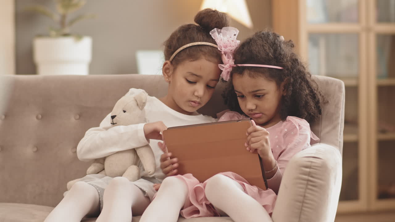 Mixed-Race Sisters Using Tablet Computer