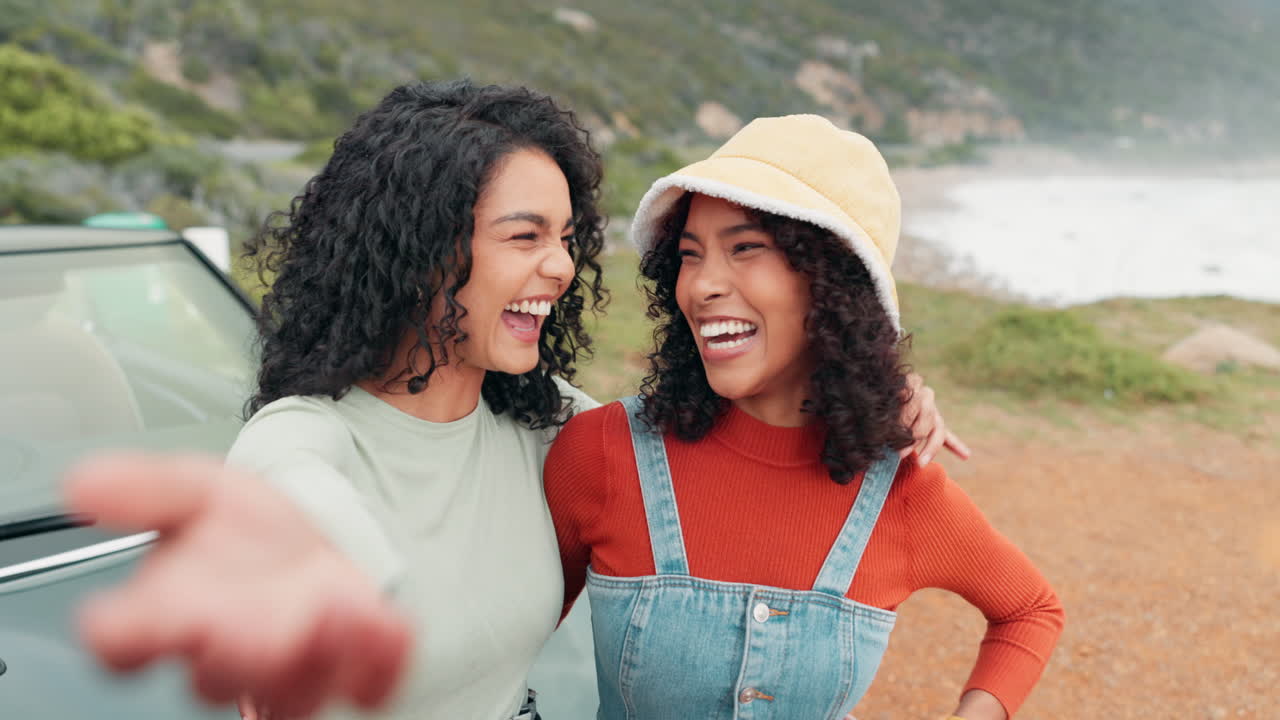 Two women taking a selfie near a car