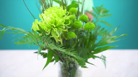 Flowers-Vase-Fresh-Fruits-Plate-Slide-and-Green-Tea-Cup-Setup-on-White-Table-with-Vibrant-Colors