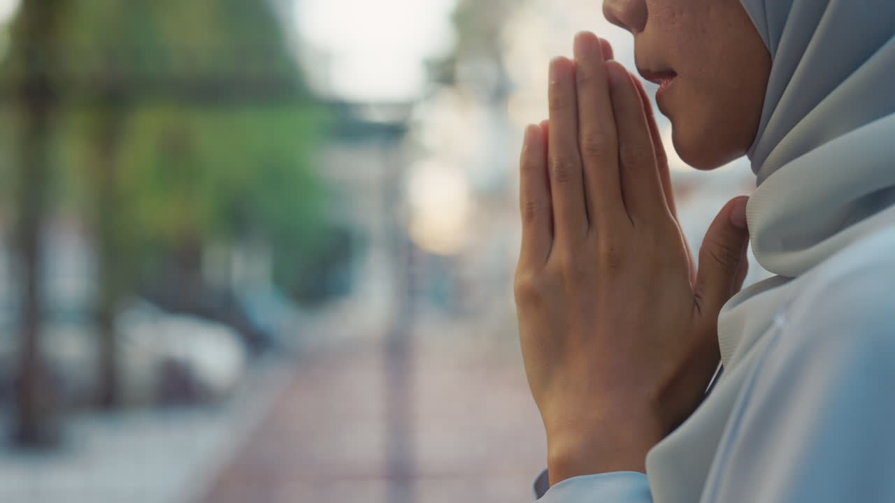 Close-up of a Muslim woman's hands in prayer or contemplation