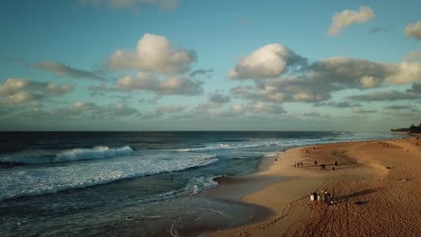 Surfers-at-Sunset-on-the-North-Shore-Beaches-of-Oahu,-Hawaii