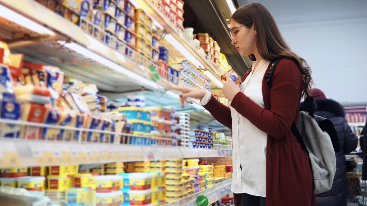 Woman Shopping for Dairy Products in a Grocery Store