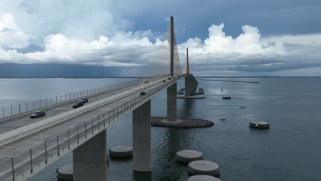 drone hyper lapse at the sunshine skyway bridge on a cloudy day with stormy clouds in the distance