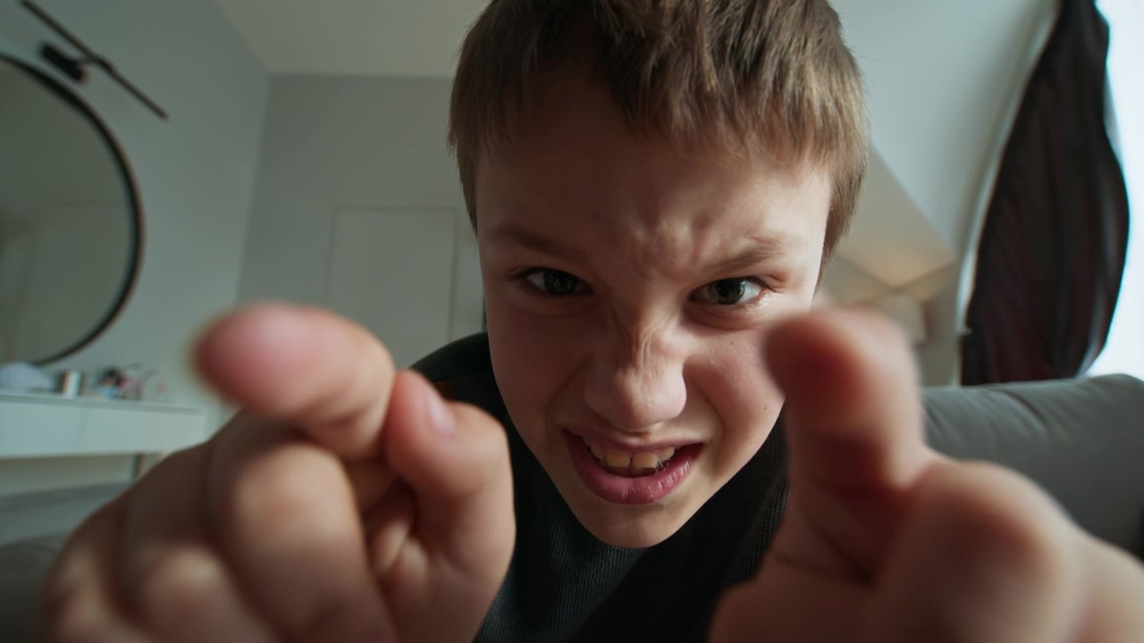 Closeup view of young boy s face and hand as he interacts with a digital screen his expression