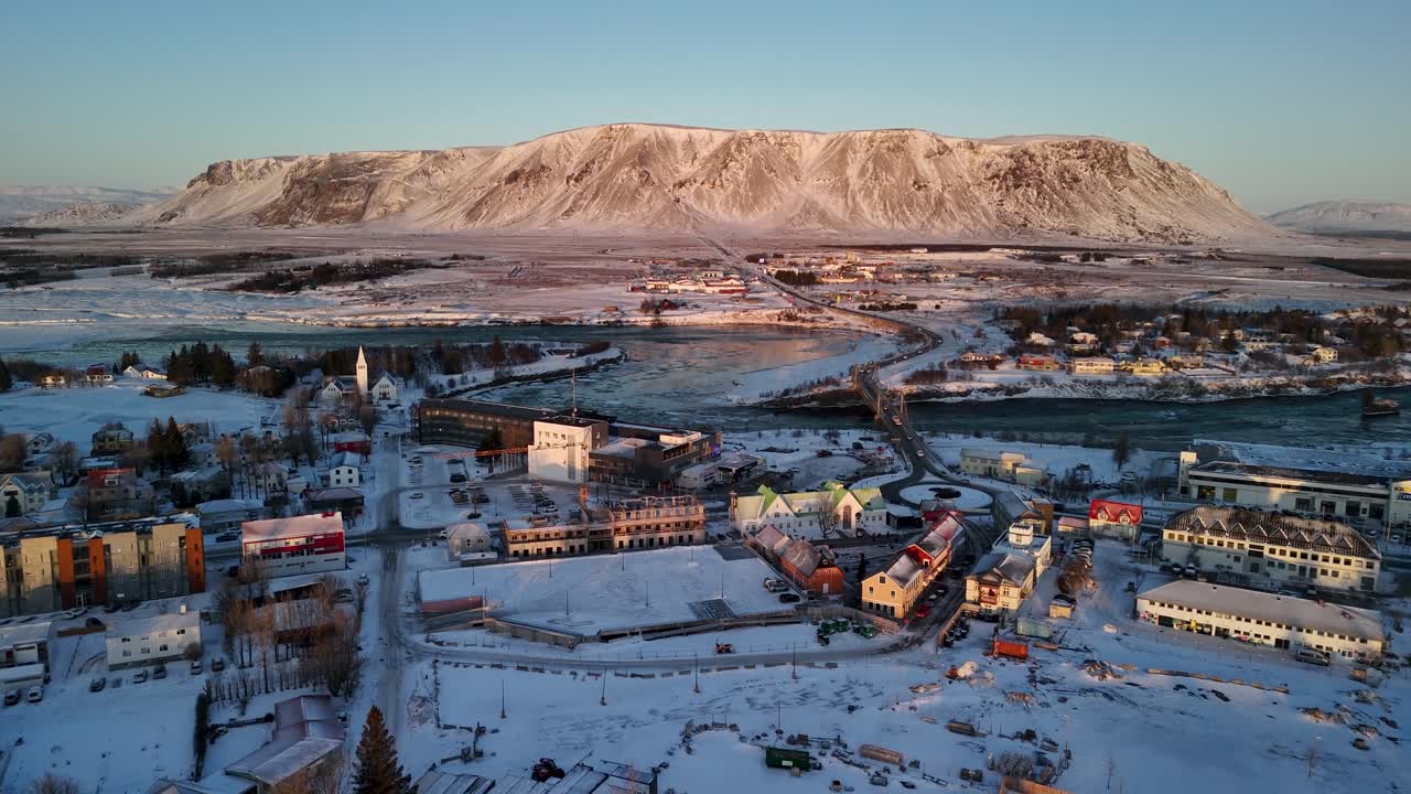 Drone view flying over the quiet town of Selfoss, Iceland toward the great mountain of Ingólfsfjall