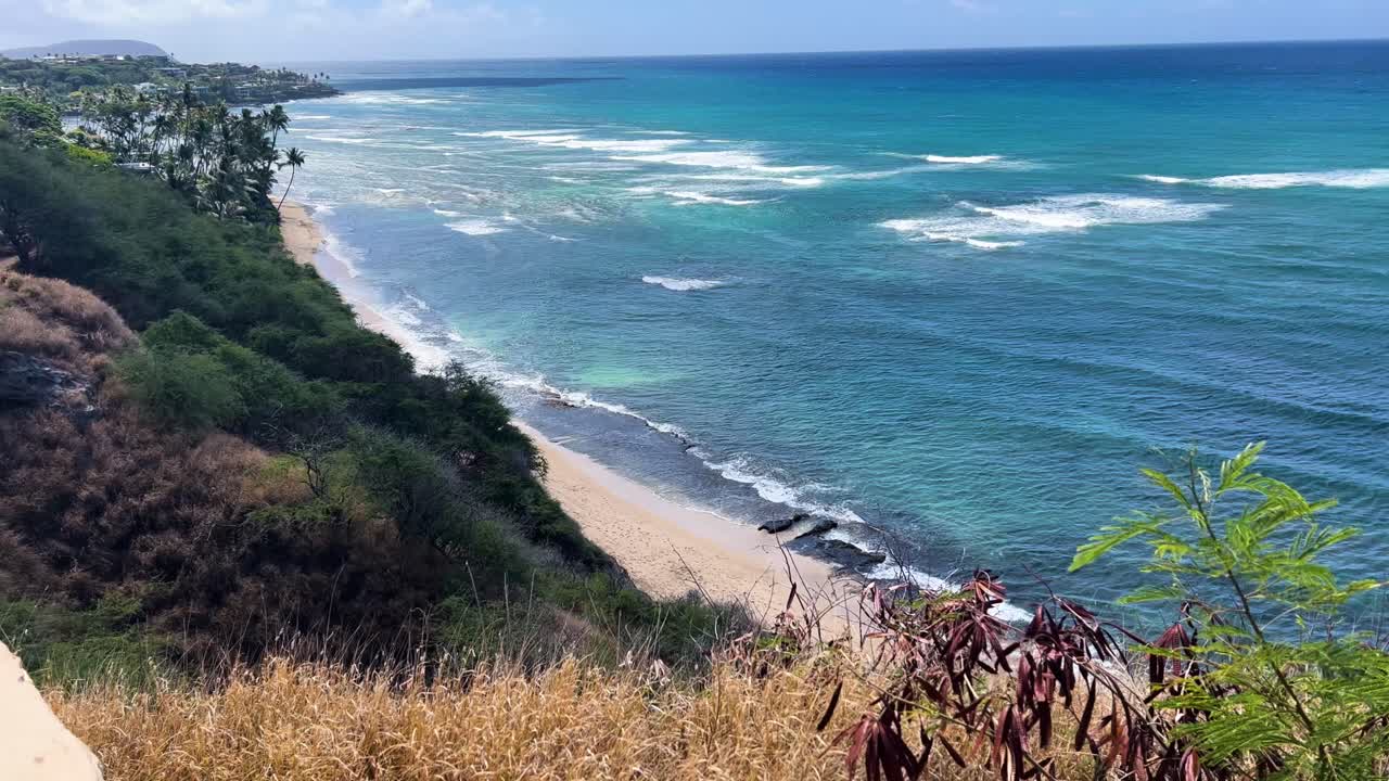Scenic view of Kuilei Cliffs Beach Park, Oahu, with waves and greenery