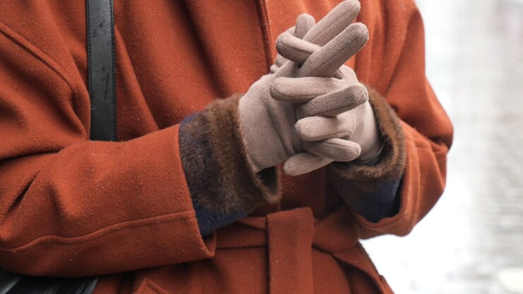 Close-up of Person's Hands Adjusting Winter Gloves