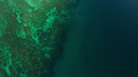 a pure and sparkling ocean waters surrounded with lush green islands captured on a fine sunny day - wide shot