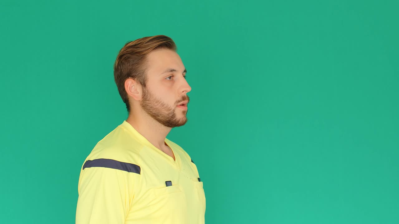 Football Soccer referee on green screen showing VAR Video Assistant Referee with hands, 4k
