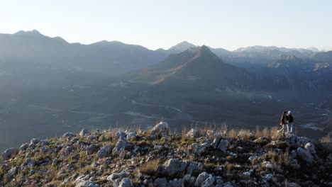 AERIAL---People-hiking-in-mountains-around-Lake-Skadar,-Montenegro,-truck-right