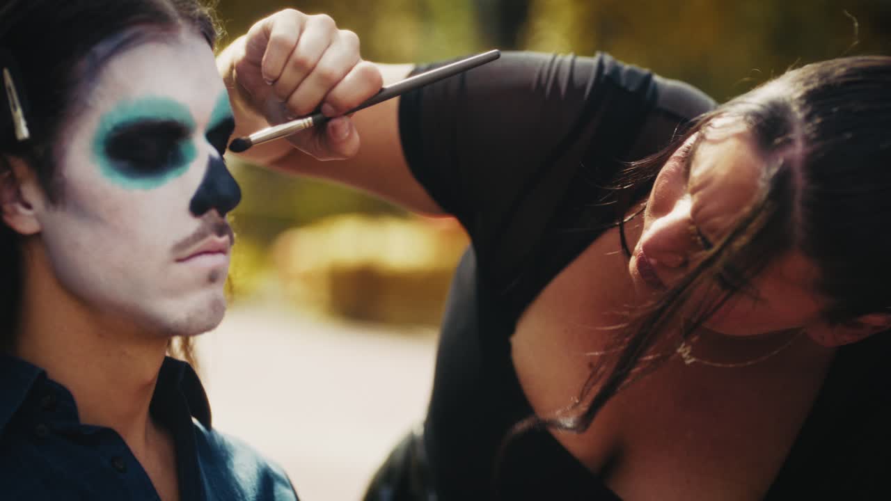 Makeup Artist Applying Day of the Dead Face Paint