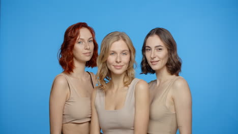 three women posing in studio