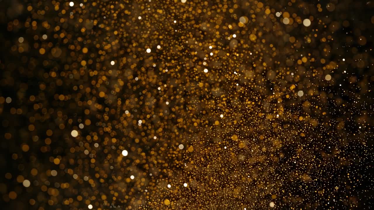 Illuminating golden dust drifting, swirling and dispersing into bokeh orbs in dark void