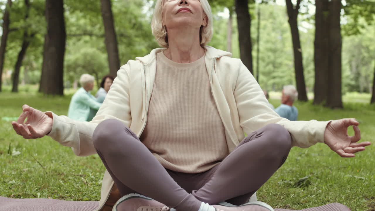 Senior Woman Meditating in a Park