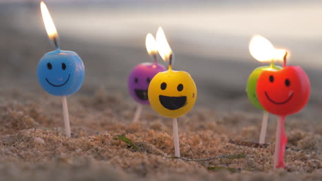 burning smiley candles on the beach