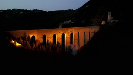 aerial view of illuminated ponte delle torri striking arched bridge in spoleto