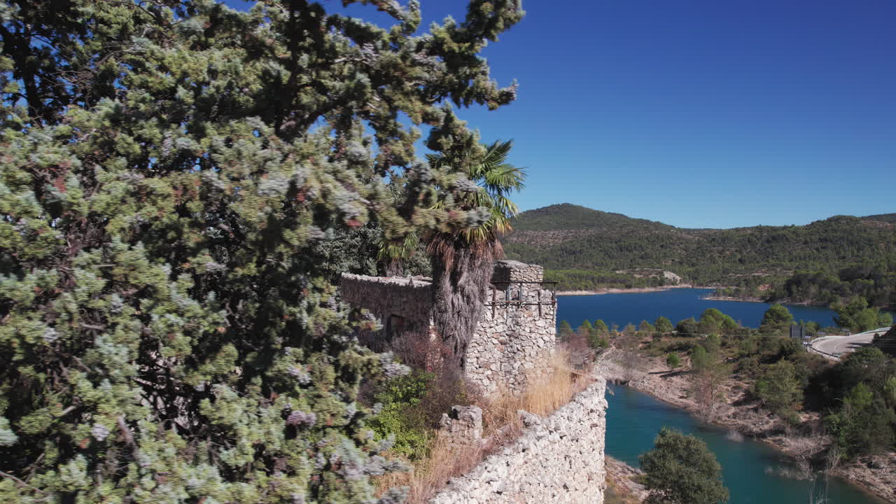 Entrepeñas reservoir near Madrid, aerial trucking shot moving left to reveal an abandoned gas station