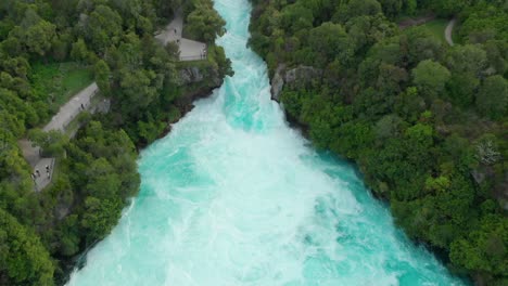 aerial drone shot rising above hukas falls, new zealand