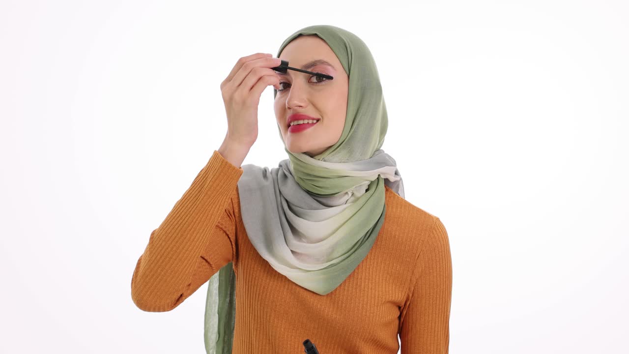 Woman in Hijab Applying Mascara