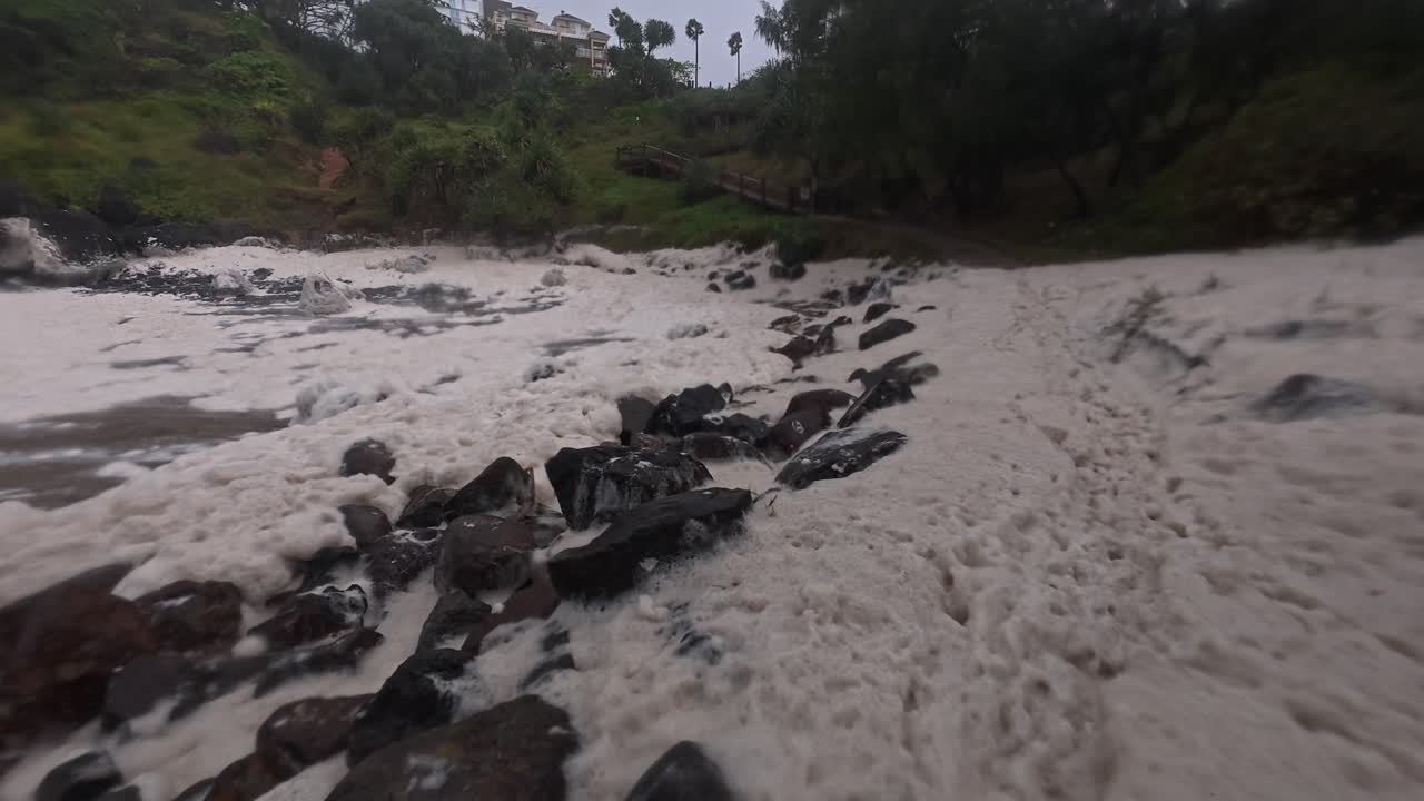 Sea Foam Flying In The Shore of Froggy Beach During Cyclone Alfred In Queensland, Australia. - wide shot