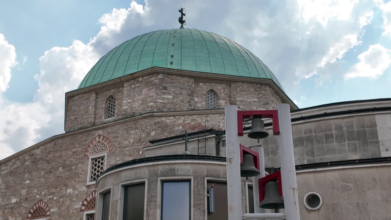 Scenic view of the Mosque of Pasha Qasim in Pécs, featuring visible bells and ornate architectural details