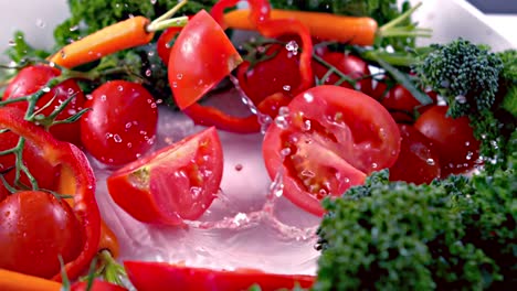 cut tomato falling into water