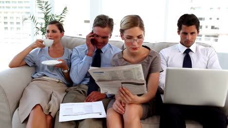 Business-people-taking-break-on-a-sofa