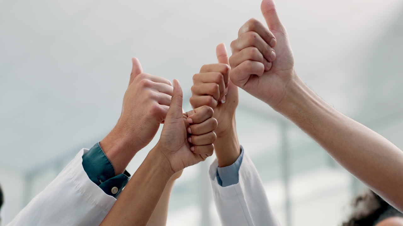 Thumbs up, success and team of doctors
